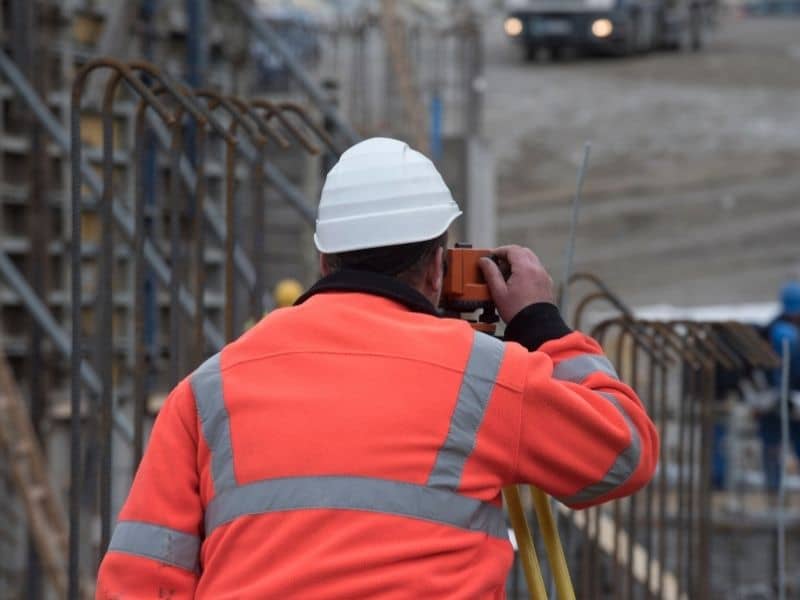 ALTA surveyor documenting conditions for an industrial property expansion project