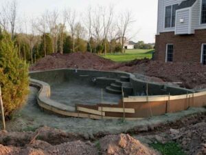 Backyard pool under construction on a tight residential lot in Frisco Texas