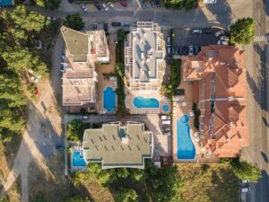 Land survey property boundaries shown around residential buildings and pools for setback and pool layout planning in Frisco Texas.